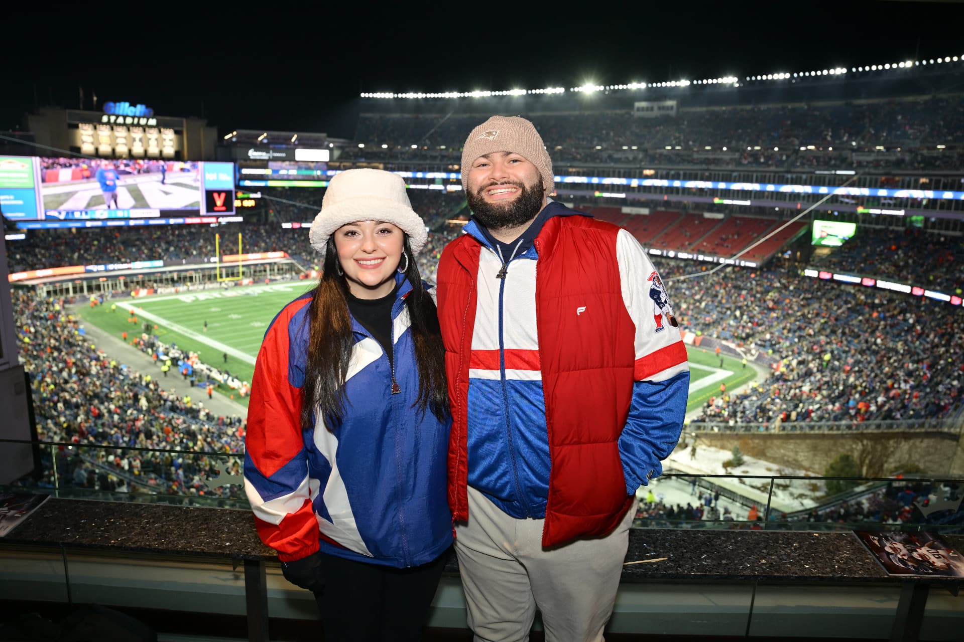 Jaime and Nolan in vintage Patriots jackets at Gillette Stadium