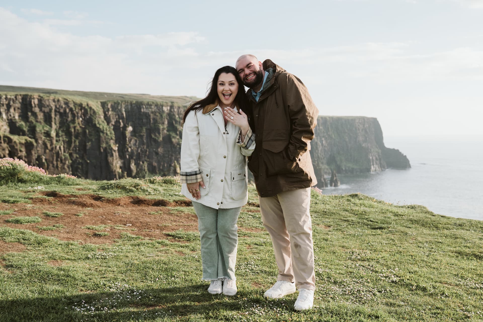 Jaime showing her engagement ring on the cliffs