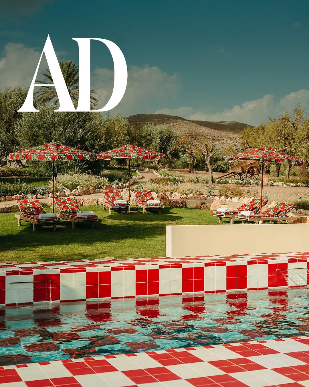 The red-and-white checkered pool at Braccialieri Resort with floral umbrellas
